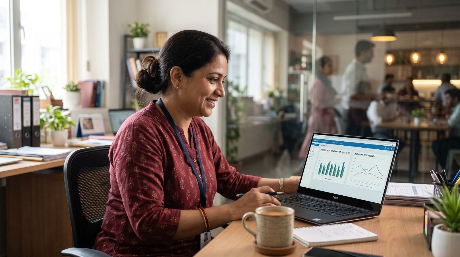 Facility manager using cafeteria management software dashboard to monitor food consumption, inventory levels, meal analytics, and cafeteria operations in real time..jpeg